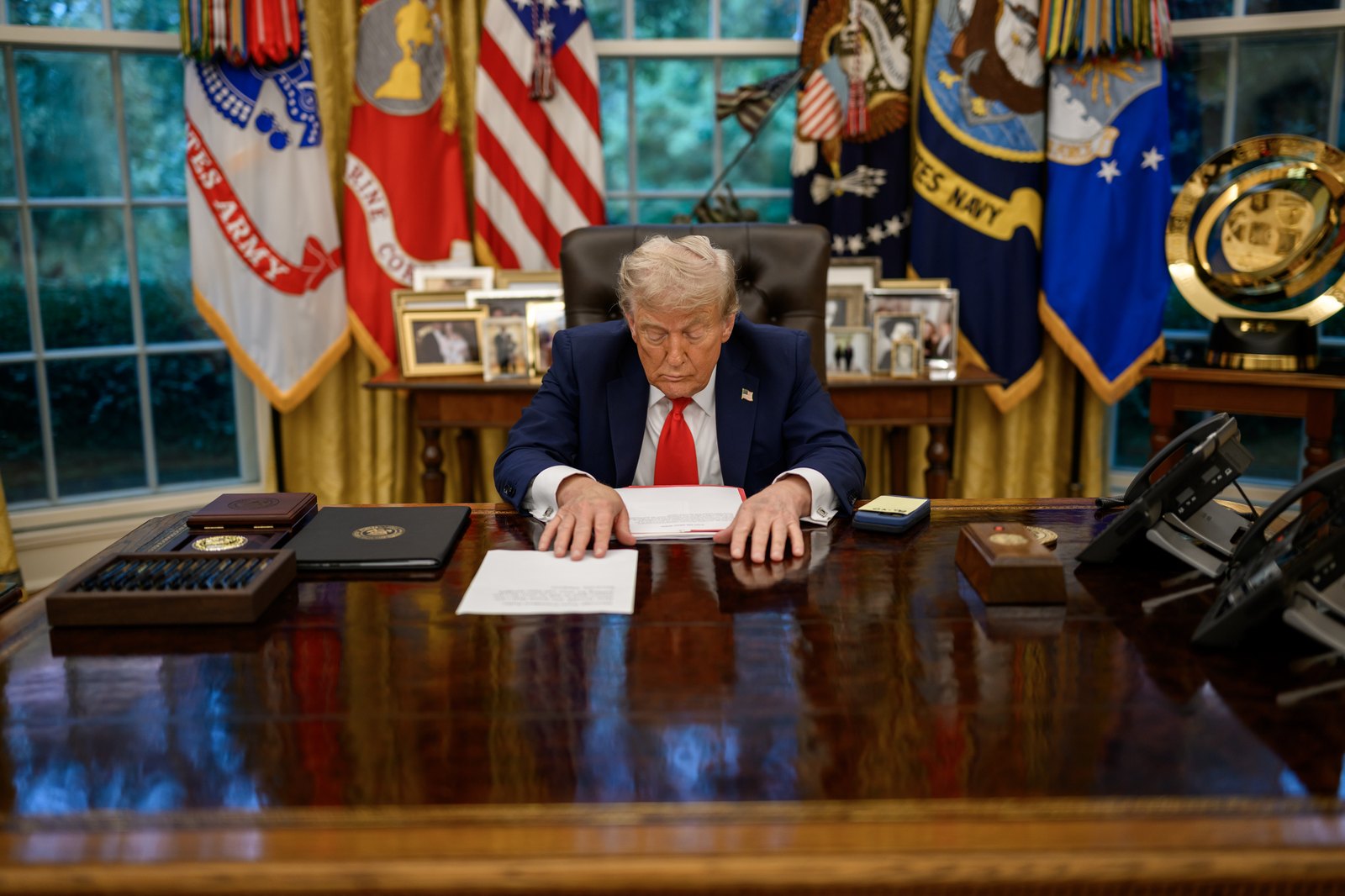 President Trump working at the Resolute Desk in the Oval Office