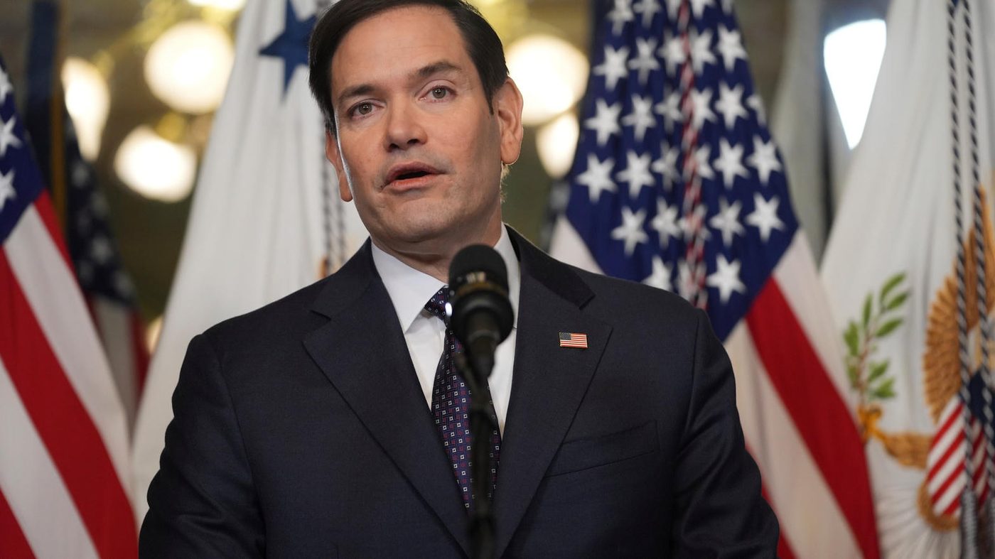 Secretary of State Marco Rubio speaking at a State Department podium